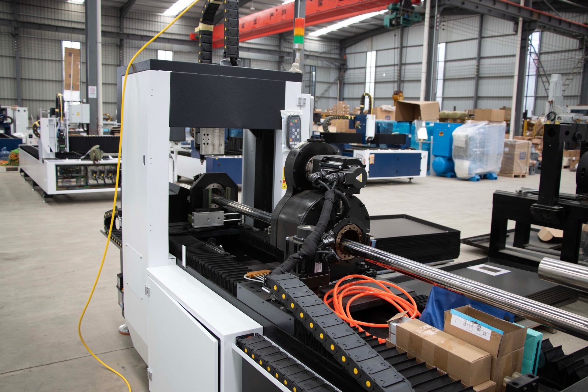 CNC machining centre with a long aluminum profile held in the chuck