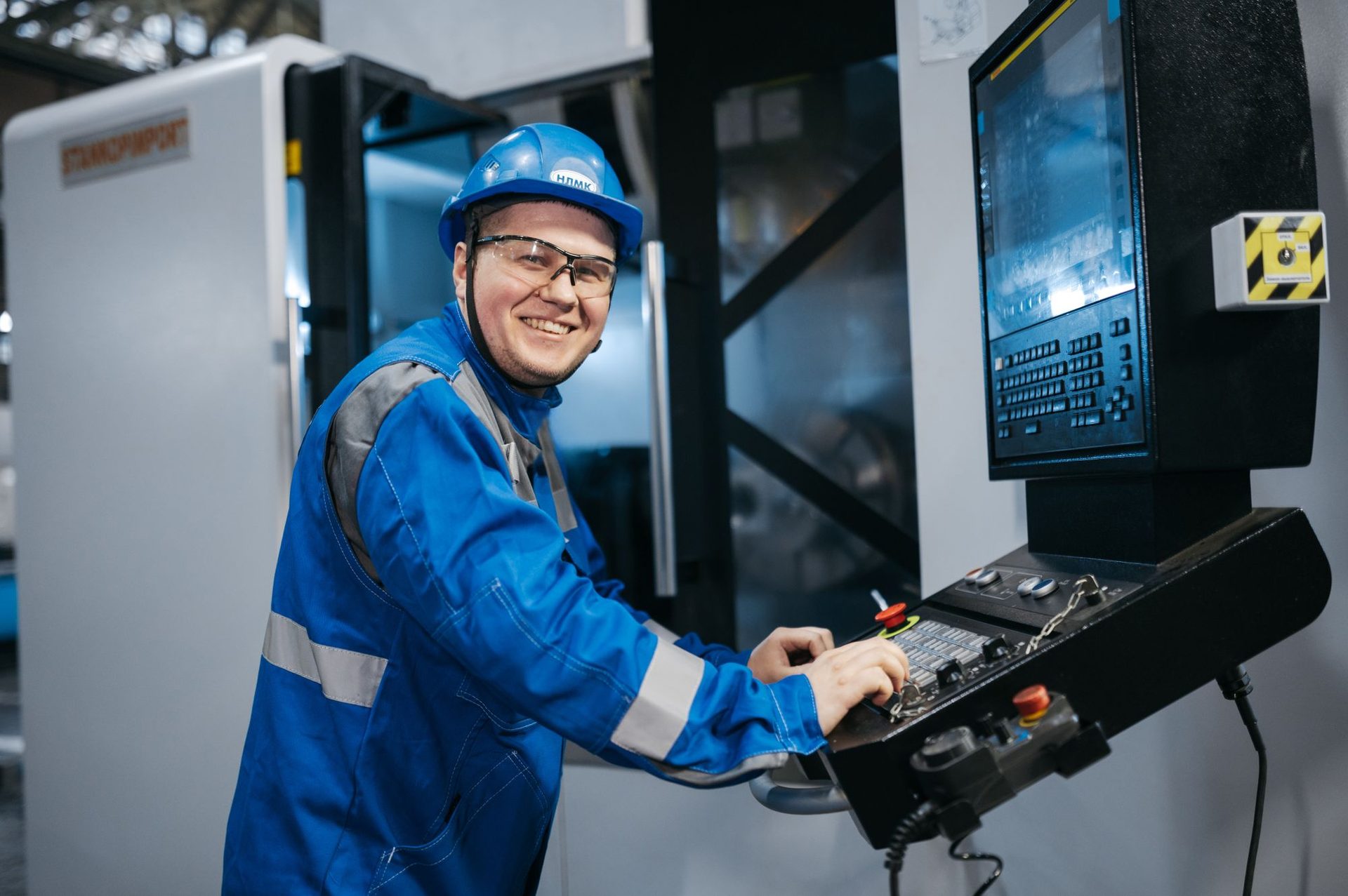 Operator at the control panel of a CNC machining centre
