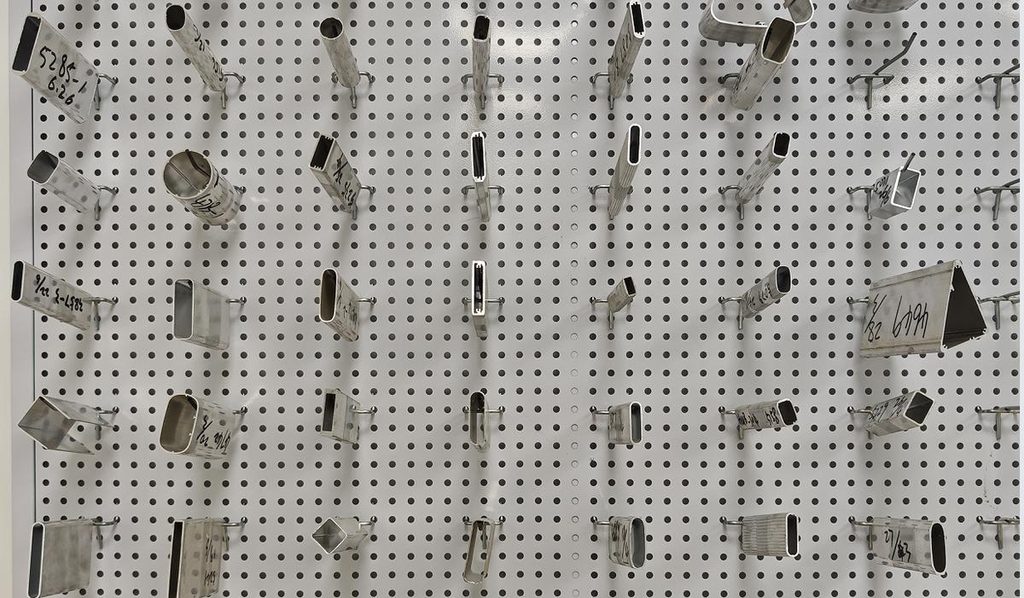 Extrusion dies for 6063 aluminum profiles racked on the tooling wall